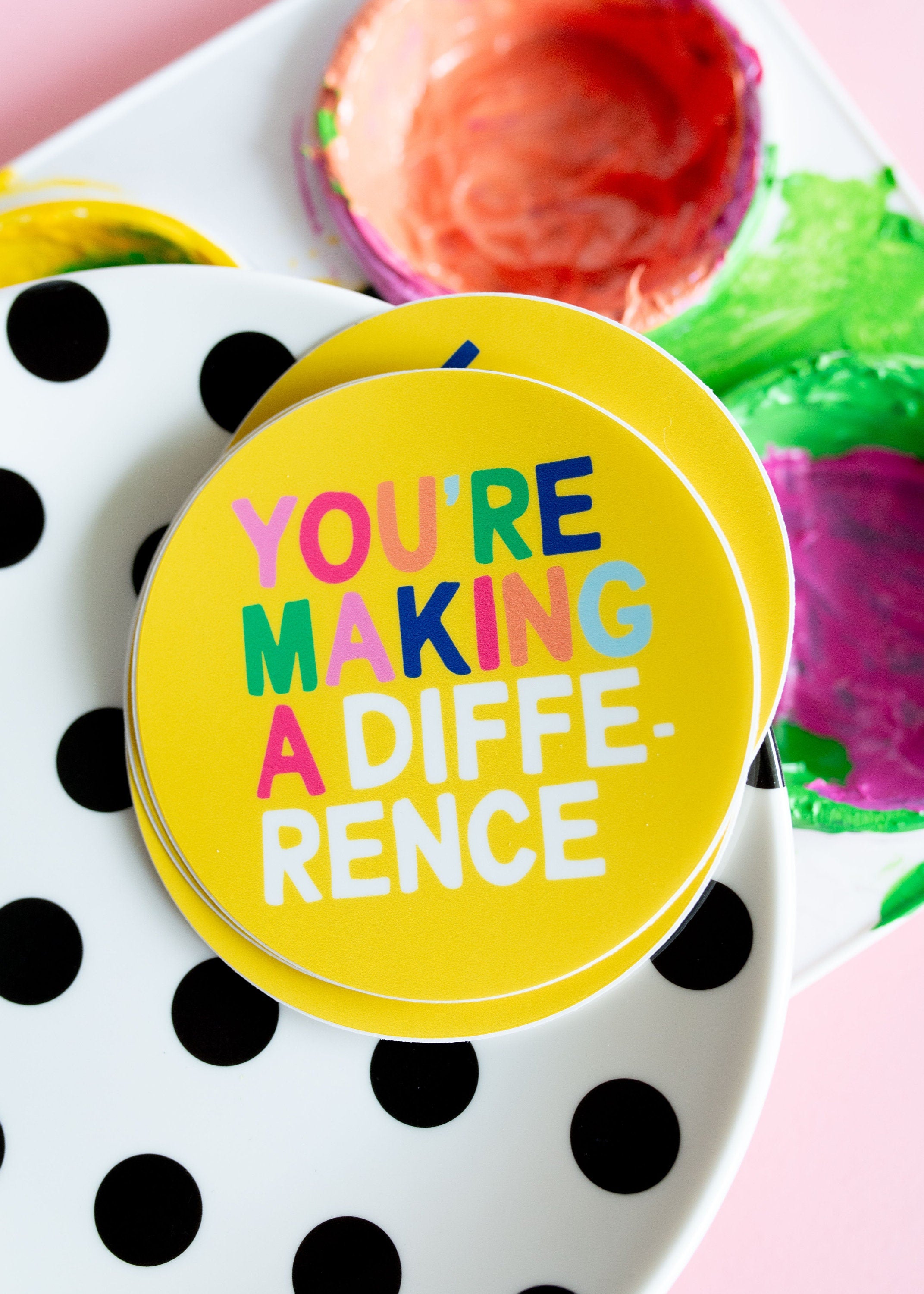Colorful stickers on a polka dot plate.