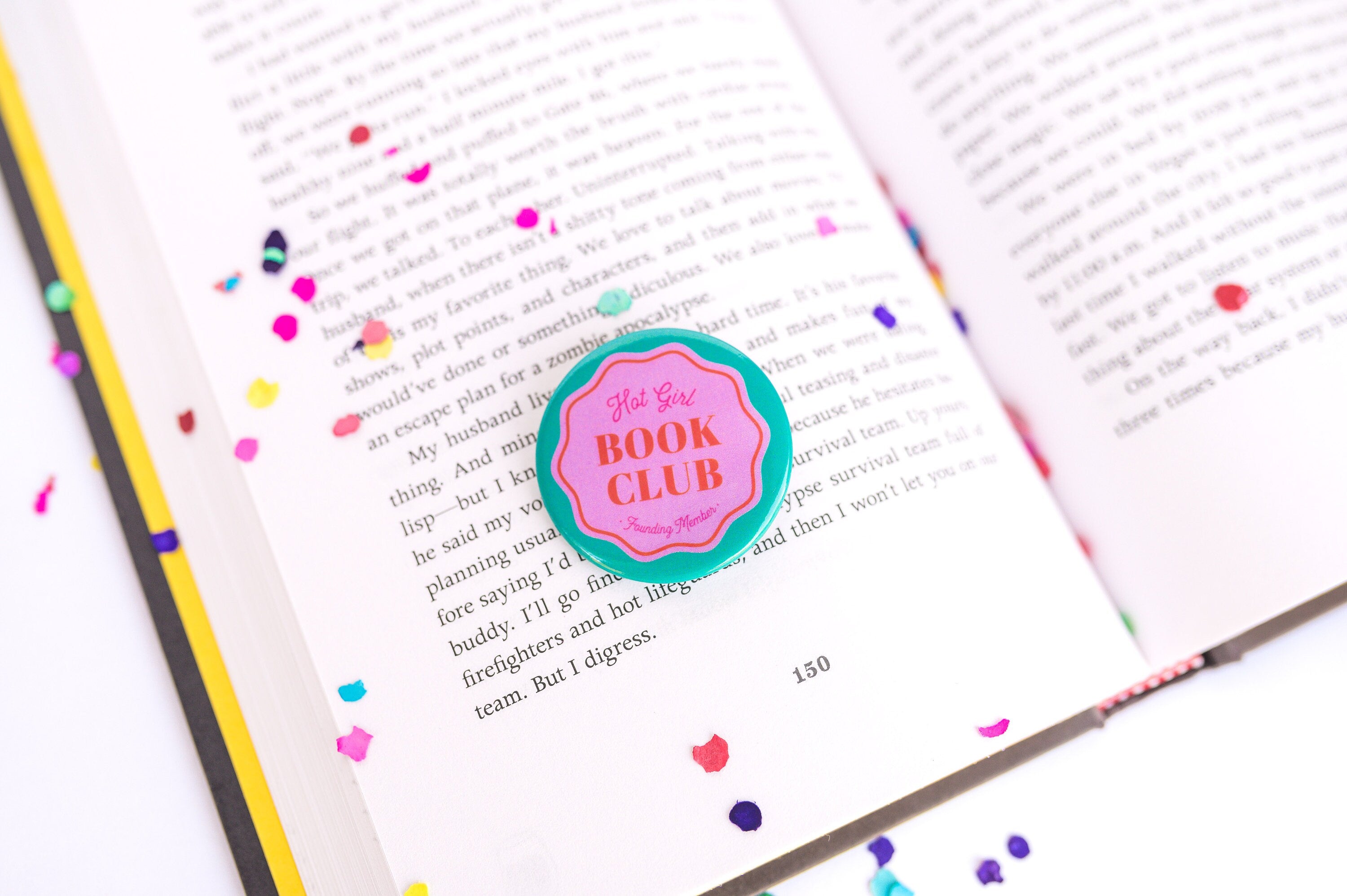 A colorful button resting on a book.
