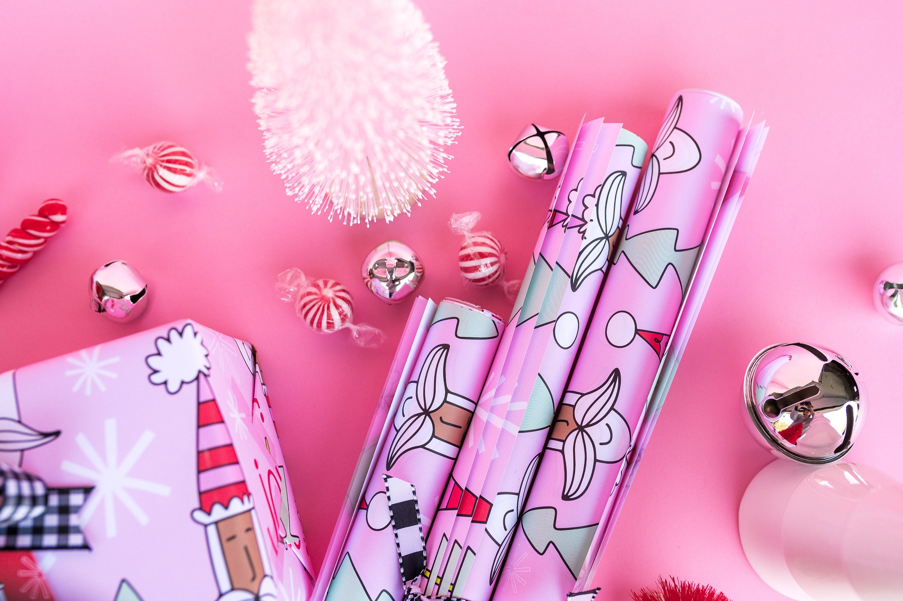Rolls of pink Santa gift wrap.